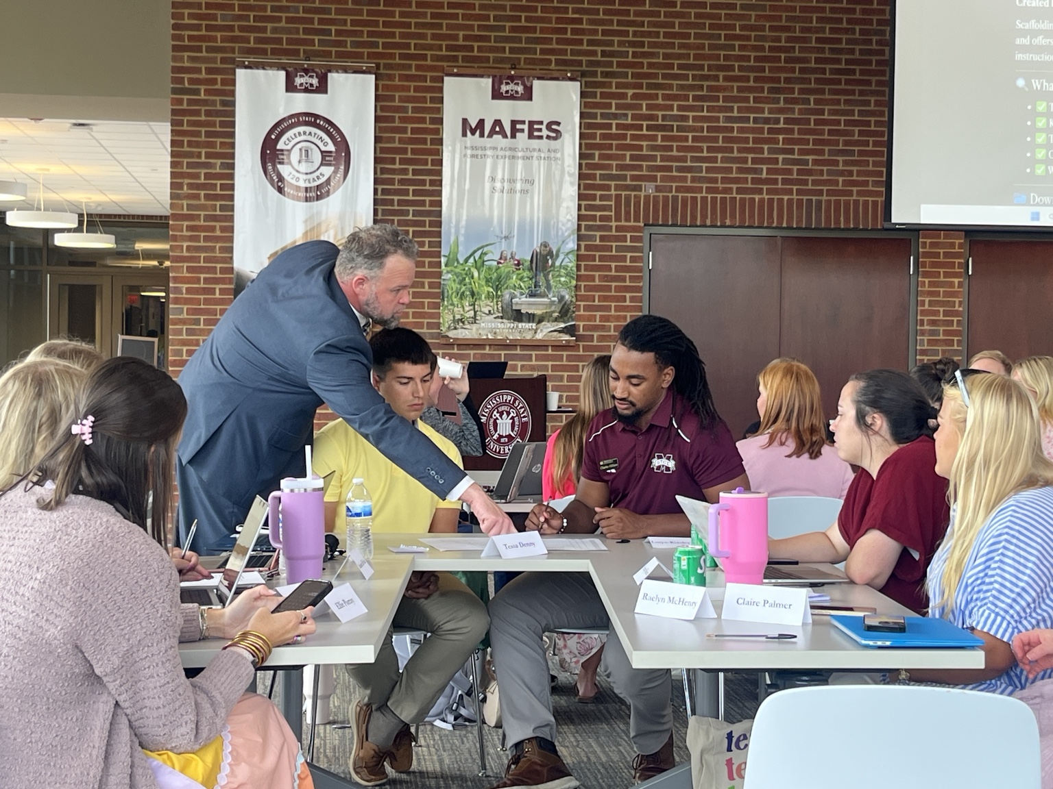 Joshua Yeager working with educators and students